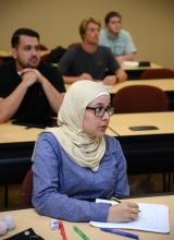 Female Muslim student at desk